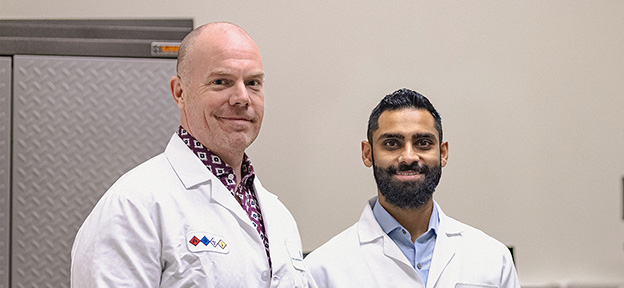 Dr. Muhammad Saad Yousuf (right), with Dr. Ted Price in lab coats