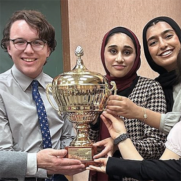 Winners of the 2024 Brain Bowl hold the trophy