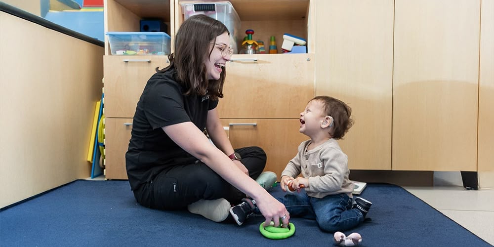 Callier Center student with a small child