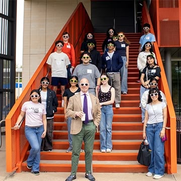 Dr. Price with students on steps