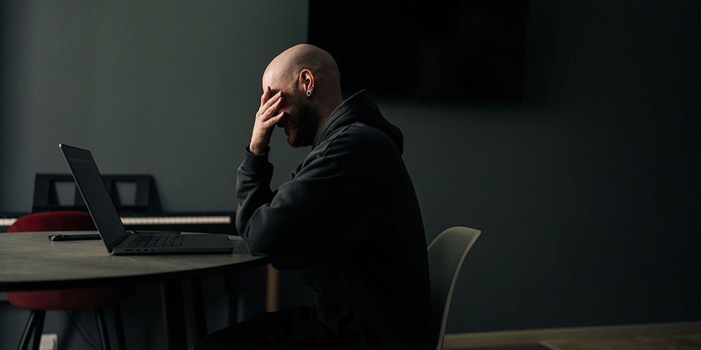 Man sitting at a desk with a computer